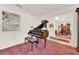Elegant living room with a grand piano and view to the dining room at 734 Riverbend Blvd, Longwood, FL 32779