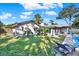 Home's backyard features a pool, grassy area, and lounge chairs at 734 Riverbend Blvd, Longwood, FL 32779