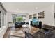 Bright Gathering room with tile floors, leather sofas, and a large TV at 734 Riverbend Blvd, Longwood, FL 32779