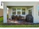 Covered patio with outdoor seating and grill, perfect for entertaining at 1092 Downswing Pl, Davenport, FL 33896