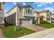 Two-story home with two-car garage and manicured lawn at 1092 Downswing Pl, Davenport, FL 33896