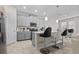 Modern kitchen with gray cabinets, white countertops, and breakfast bar at 1092 Downswing Pl, Davenport, FL 33896