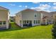 Two-story home with covered patio, grassy yard, and privacy at 1092 Downswing Pl, Davenport, FL 33896