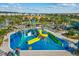 Community waterpark with slides, splash pad, and lounge chairs at 1092 Downswing Pl, Davenport, FL 33896