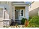 Inviting front entrance with stone accents and landscaping at 1092 Downswing Pl, Davenport, FL 33896