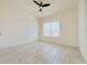 Bright bedroom with tile floors and ceiling fan at 3995 Scarlet Branch Rd, Orlando, FL 32824