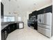 Modern kitchen with dark cabinets, stainless steel appliances, and granite countertops at 3995 Scarlet Branch Rd, Orlando, FL 32824