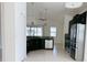 Modern kitchen with dark cabinets, stainless steel appliances, and granite countertops at 3995 Scarlet Branch Rd, Orlando, FL 32824