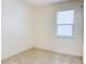 Simple bedroom with tile floors and window with blinds at 3995 Scarlet Branch Rd, Orlando, FL 32824