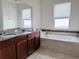 Main bathroom with double vanity and garden tub at 3995 Scarlet Branch Rd, Orlando, FL 32824