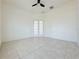 Bright bedroom with tile floors, ceiling fan, and French doors at 3995 Scarlet Branch Rd, Orlando, FL 32824