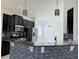 Modern kitchen with a breakfast bar and dark wood cabinets at 3995 Scarlet Branch Rd, Orlando, FL 32824