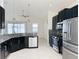 Modern kitchen features dark cabinetry, granite countertops, and stainless steel appliances at 3995 Scarlet Branch Rd, Orlando, FL 32824