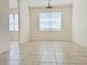 Bright dining room with tile floors and a view into another room at 3995 Scarlet Branch Rd, Orlando, FL 32824