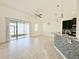 Bright and spacious living room with tile flooring and sliding glass doors leading to the backyard at 3995 Scarlet Branch Rd, Orlando, FL 32824