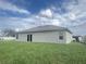Rear view of a single-story house with gray siding at 1910 Lakeview Ln, Poinciana, FL 34759