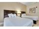 Bright bedroom featuring two double beds with plush bedding at 3000 Maingate Ln # 113, Kissimmee, FL 34747