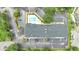 Aerial view showing building, pool, and surrounding parking lot at 3000 Maingate Ln # 113, Kissimmee, FL 34747