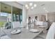 Spacious dining room with sliding glass doors leading to backyard and stylish chandelier at 1771 Three Bars Rd, Kissimmee, FL 34744
