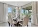 Bright dining room with a table for six, a chandelier, and large windows overlooking the backyard at 1771 Three Bars Rd, Kissimmee, FL 34744