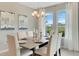 Elegant dining room features a large table and chandelier, with light-filled windows at 1771 Three Bars Rd, Kissimmee, FL 34744
