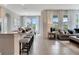 Open concept kitchen and living area with an island and granite countertops at 1771 Three Bars Rd, Kissimmee, FL 34744