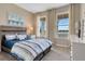 Bright bedroom with lake view, wood-like flooring and window treatments at 1771 Three Bars Rd, Kissimmee, FL 34744