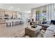 Open floor plan showcases a kitchen island, breakfast bar, stainless steel appliances and living room at 1771 Three Bars Rd, Kissimmee, FL 34744