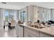 Open concept kitchen with island, granite counters, stainless steel appliances and view of dining area at 1771 Three Bars Rd, Kissimmee, FL 34744