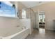 Clean bathroom with soaking tub, shower and toilet at 1771 Three Bars Rd, Kissimmee, FL 34744