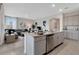 Open kitchen boasts an island with seating, stainless steel appliances, and granite countertops at 1771 Three Bars Rd, Kissimmee, FL 34744