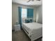 Bright bedroom with a full-size bed and teal curtains at 2813 Bookmark Dr, Kissimmee, FL 34746