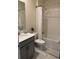 Clean bathroom with gray vanity and a bathtub at 2813 Bookmark Dr, Kissimmee, FL 34746
