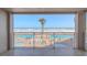Stunning ocean view from balcony with two pools and palm trees below at 5501 S Atlantic Ave # 307, New Smyrna Beach, FL 32169
