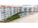Beachfront property featuring a large pool and lush landscaping at 5501 S Atlantic Ave # 307, New Smyrna Beach, FL 32169