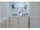 Neat laundry closet with washer and dryer, and shelving for storage at 5501 S Atlantic Ave # 307, New Smyrna Beach, FL 32169