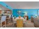 Bright dining room with white table and kitchen access at 5501 S Atlantic Ave # 307, New Smyrna Beach, FL 32169