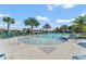 Inviting community pool with palm trees and lounge chairs at 1777 Three Bars Rd, Kissimmee, FL 34744