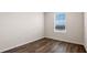 Empty bedroom with large window and wood-look flooring at 1230 Balsam Dr, Davenport, FL 33837