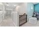 Upstairs hallway with carpeted flooring and safety gate at 5443 Carrara Ct, St Cloud, FL 34771