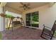 Covered patio with brick flooring, a wooden swing, and a rocking chair at 5443 Carrara Ct, St Cloud, FL 34771