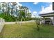 Backyard with grassy area, swing set, and trees in the background at 5443 Carrara Ct, St Cloud, FL 34771