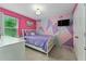 Bedroom with geometric accent wall and TV at 5443 Carrara Ct, St Cloud, FL 34771