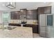 Modern kitchen with granite countertops, stainless steel appliances, and dark wood cabinetry at 5443 Carrara Ct, St Cloud, FL 34771