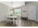 Bright dining room with white table and chairs, wood-look flooring at 5443 Carrara Ct, St Cloud, FL 34771