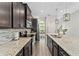 Modern kitchen with dark cabinetry, granite countertops, and an island at 5443 Carrara Ct, Saint Cloud, FL 34771