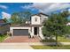 Two-story house with solar panels and landscaped yard at 5443 Carrara Ct, Saint Cloud, FL 34771