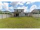 Large backyard with green grass, a swing set, and a view of the house at 5443 Carrara Ct, St Cloud, FL 34771