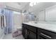 Bathroom with dark vanity, white countertop, and bathtub at 5443 Carrara Ct, St Cloud, FL 34771