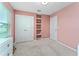 bedroom with built-in shelves and pink walls at 5443 Carrara Ct, Saint Cloud, FL 34771